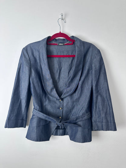 A blue-gray striped long-sleeve shirt with a tie waist and button front, hanging on a red hanger against a plain white background.