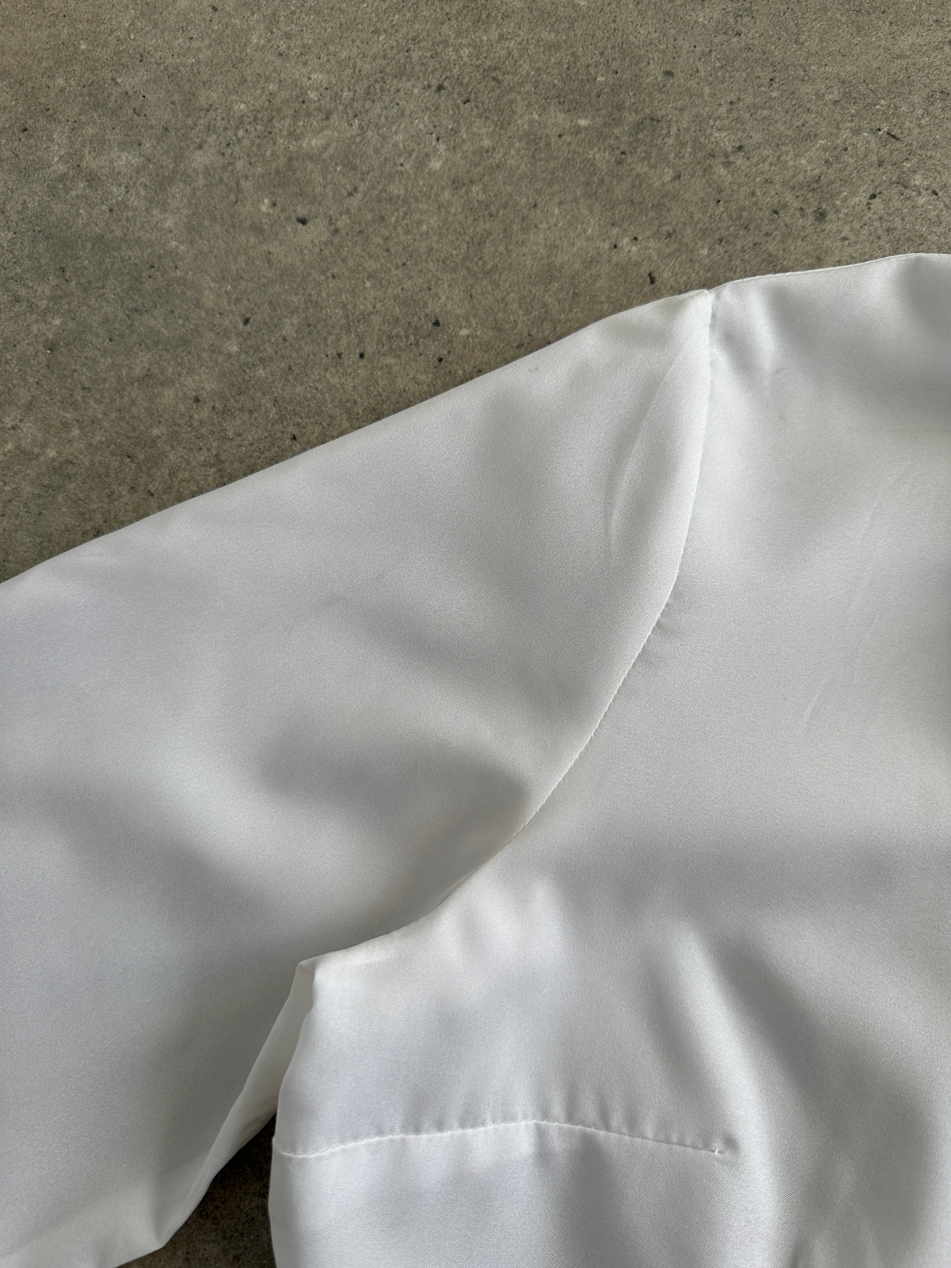 Vintage 1980s neck tie shirt in black and white, casual style, featuring a classic collar and vintage branding.