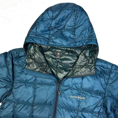 Close-up of a blue Montbell Superior Down Parka puffer jacket showing the hood and logo.