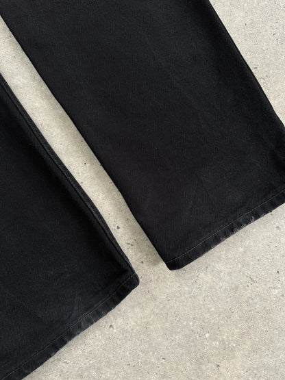 Levi's 521 tapered straight-leg denim jeans in W31, showing classic blue denim fabric and a modern fit.