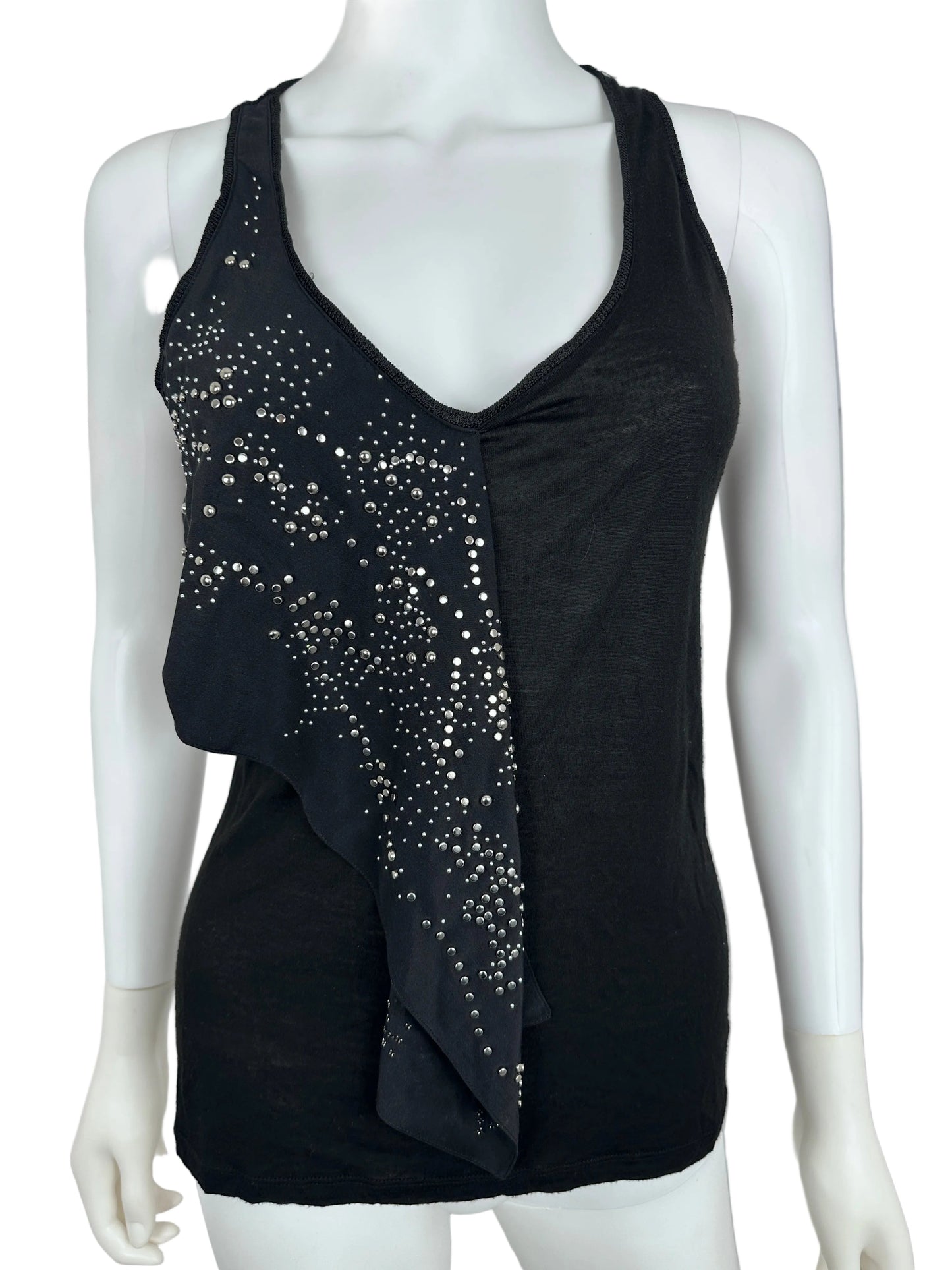 Black top with stud details on a mannequin against a neutral background