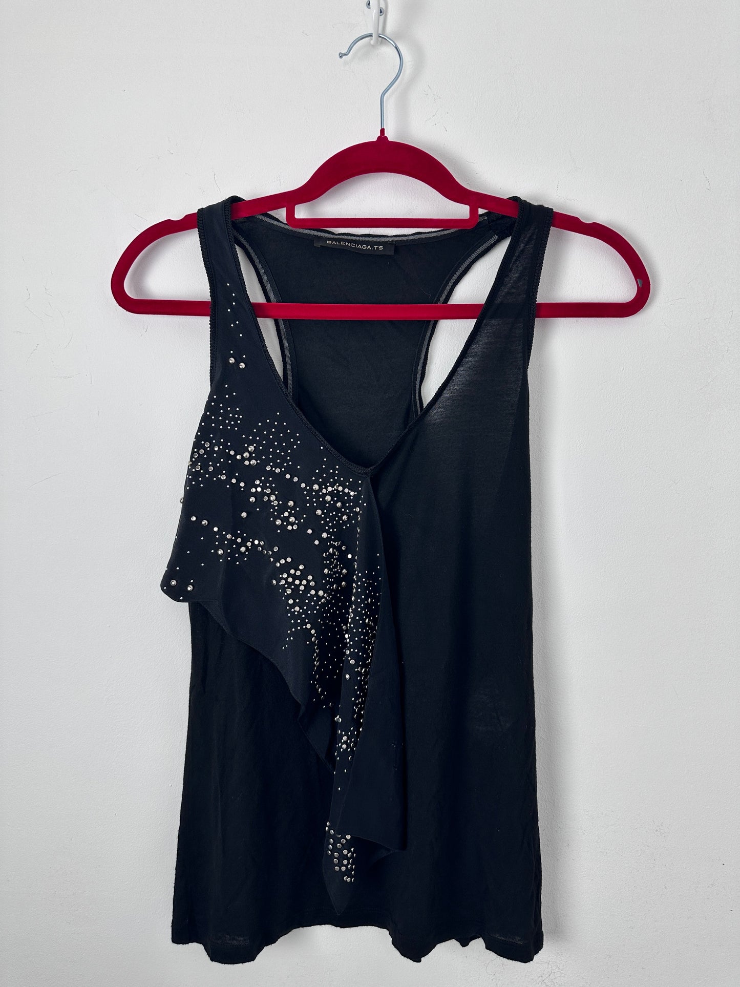 Black tank with stud details on a white background