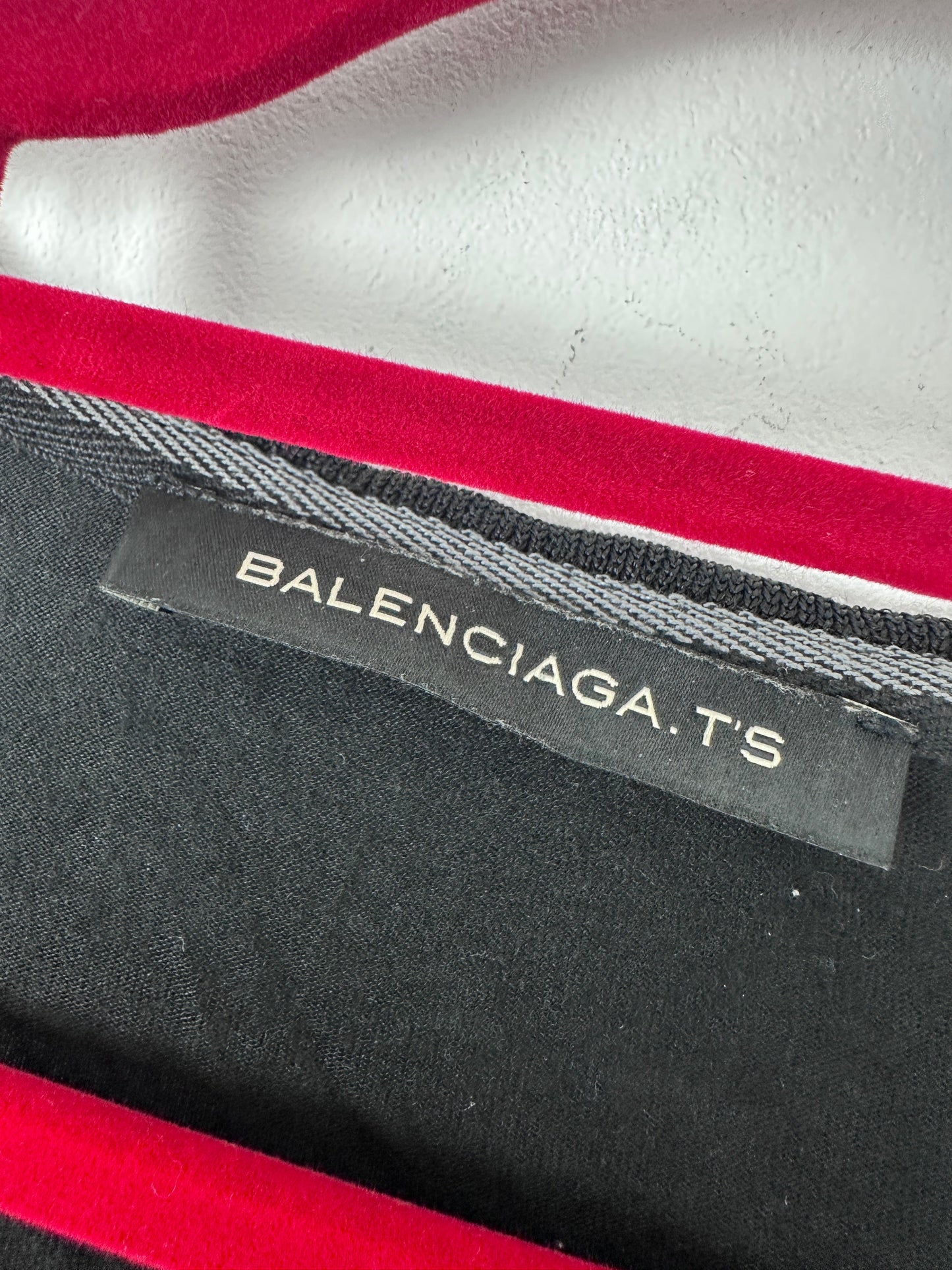 Balenciaga label on a garment with red and gray colors