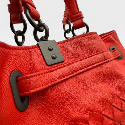 https://cdn.shopify.com/s/files/1/0564/9376/8855/files/Bottega_Veneta_Handtasche_Bucket_Intrecciato_mit_Umhaengegurt_aus_Leder_rot_vintage_designer_handbag_3333.webp?v=1744271924