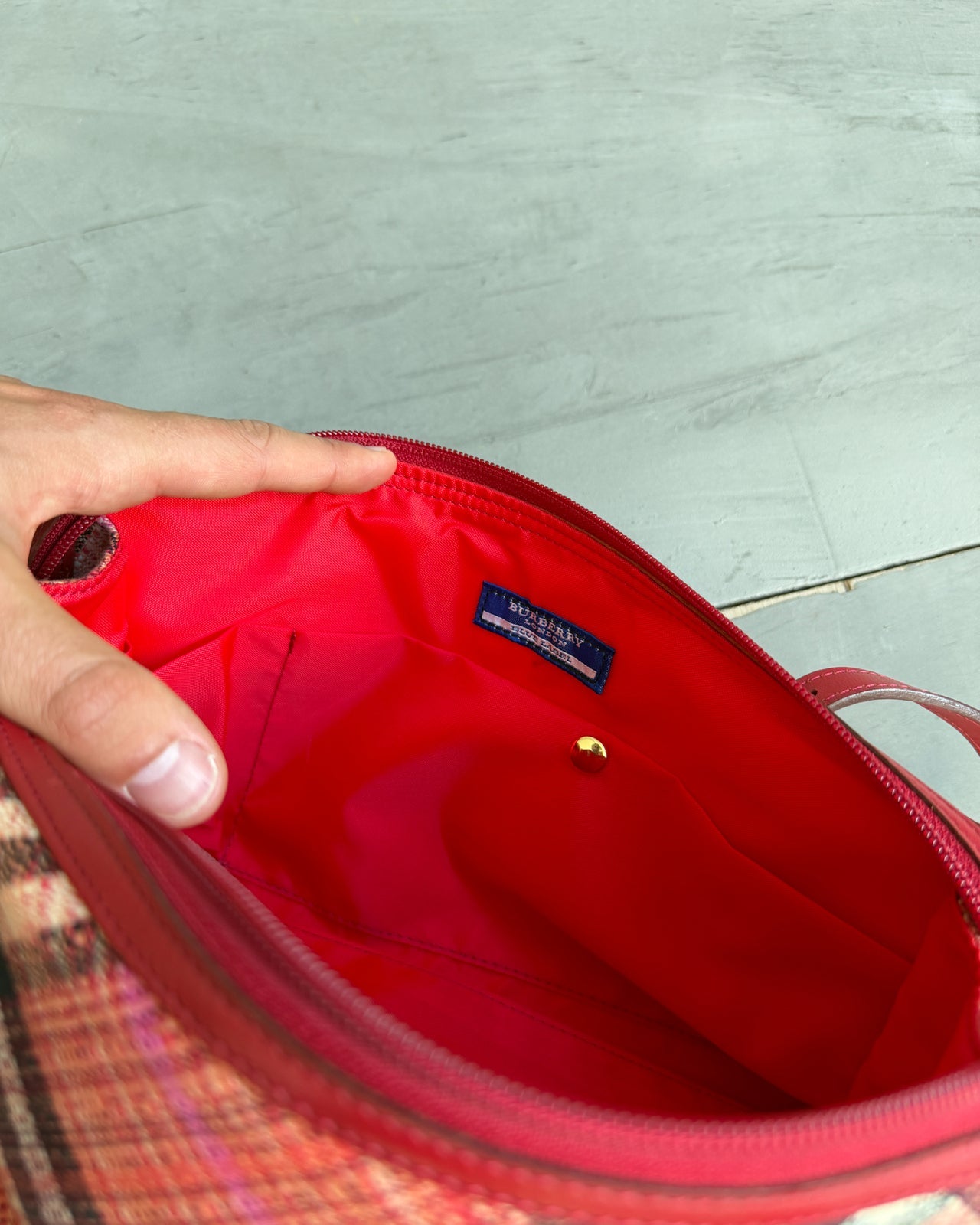 Burberry Blue Label Nova Print Red Bag-on a concrete background