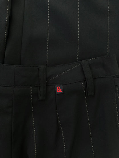 Dolce & Gabbana 2000s wool trousers in size W28, tailored fit, dark color, with classic waistband and front pockets.