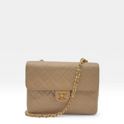 https://cdn.shopify.com/s/files/1/0564/9376/8855/files/Chanel_Flap_Bag-Beige5193.webp?v=1754669919
