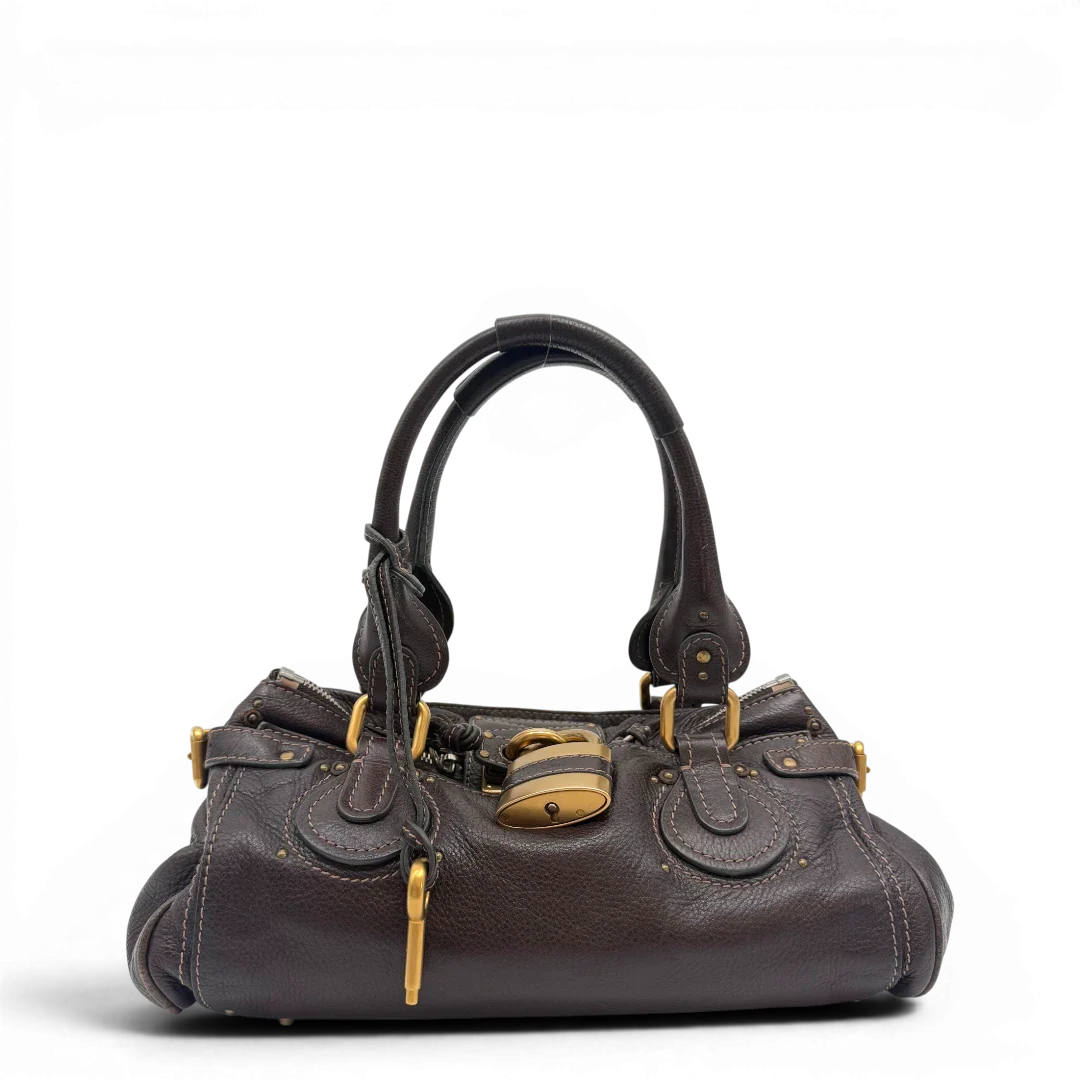 https://cdn.shopify.com/s/files/1/0564/9376/8855/files/Chloe_Handtasche_Paddington_aus_Leder_dunkelbraun_vintage6980.webp?v=1779290033