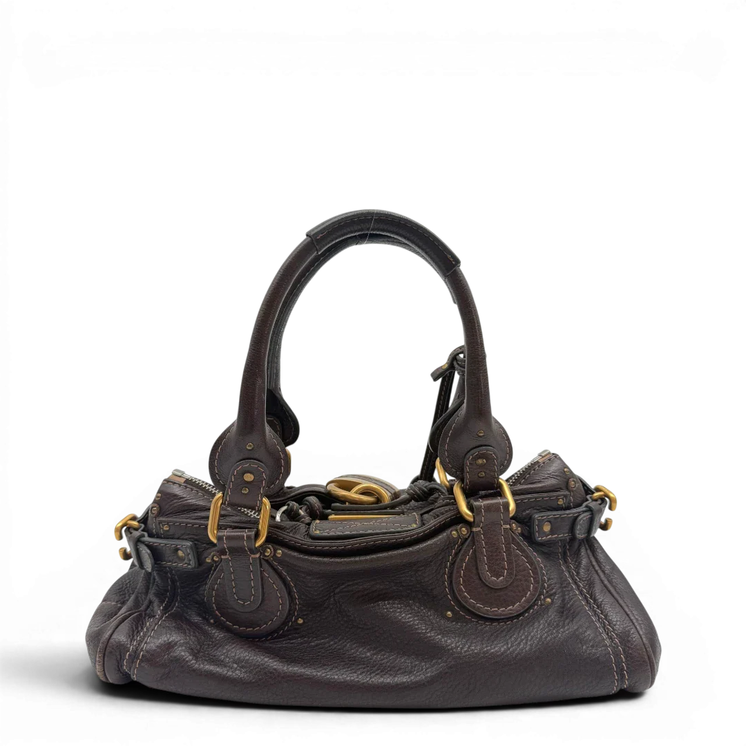 https://cdn.shopify.com/s/files/1/0564/9376/8855/files/Chloe_Handtasche_Paddington_aus_Leder_dunkelbraun_vintage6984.webp?v=1779290033