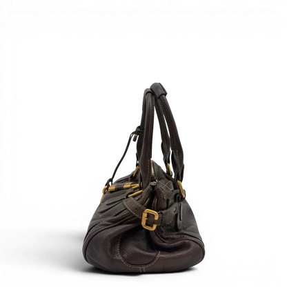 https://cdn.shopify.com/s/files/1/0564/9376/8855/files/Chloe_Handtasche_Paddington_aus_Leder_dunkelbraun_vintage6985.webp?v=1779290033