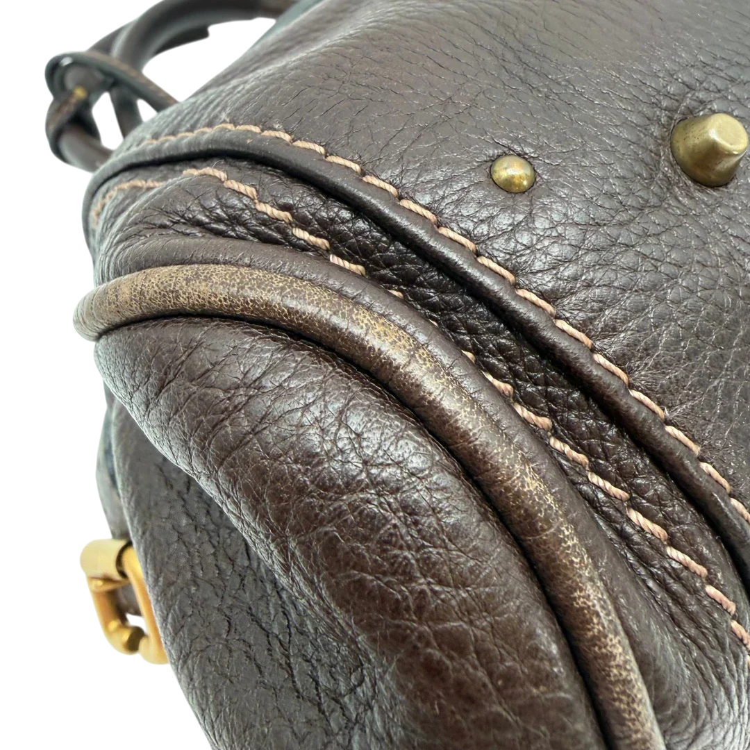 https://cdn.shopify.com/s/files/1/0564/9376/8855/files/Chloe_Handtasche_Paddington_aus_Leder_dunkelbraun_vintage6989.webp?v=1779290037