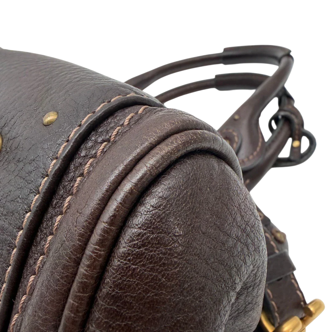 https://cdn.shopify.com/s/files/1/0564/9376/8855/files/Chloe_Handtasche_Paddington_aus_Leder_dunkelbraun_vintage6990.webp?v=1779290033