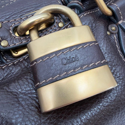https://cdn.shopify.com/s/files/1/0564/9376/8855/files/Chloe_Handtasche_Paddington_aus_Leder_dunkelbraun_vintage6993.webp?v=1779290033