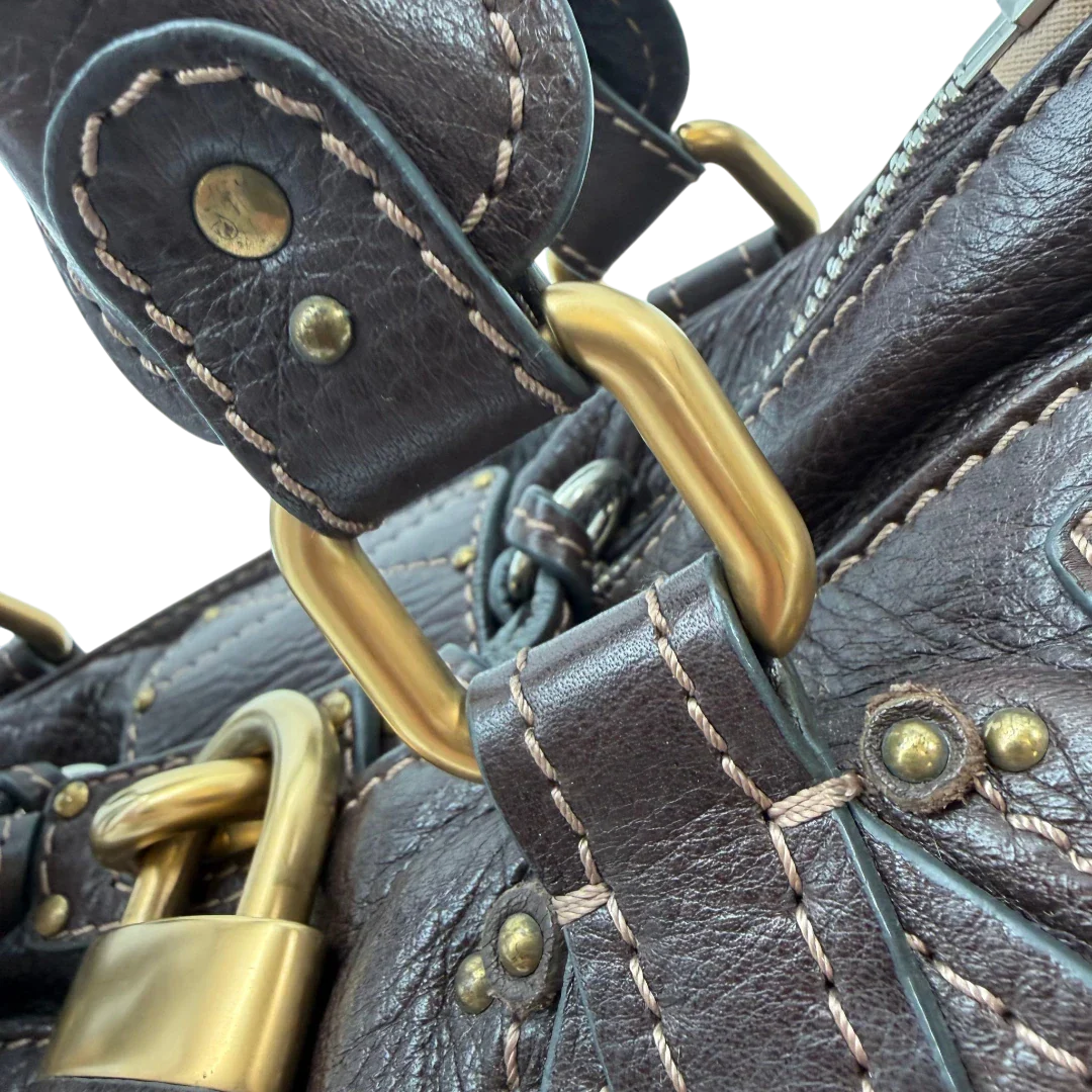 https://cdn.shopify.com/s/files/1/0564/9376/8855/files/Chloe_Handtasche_Paddington_aus_Leder_dunkelbraun_vintage6994.webp?v=1779290033