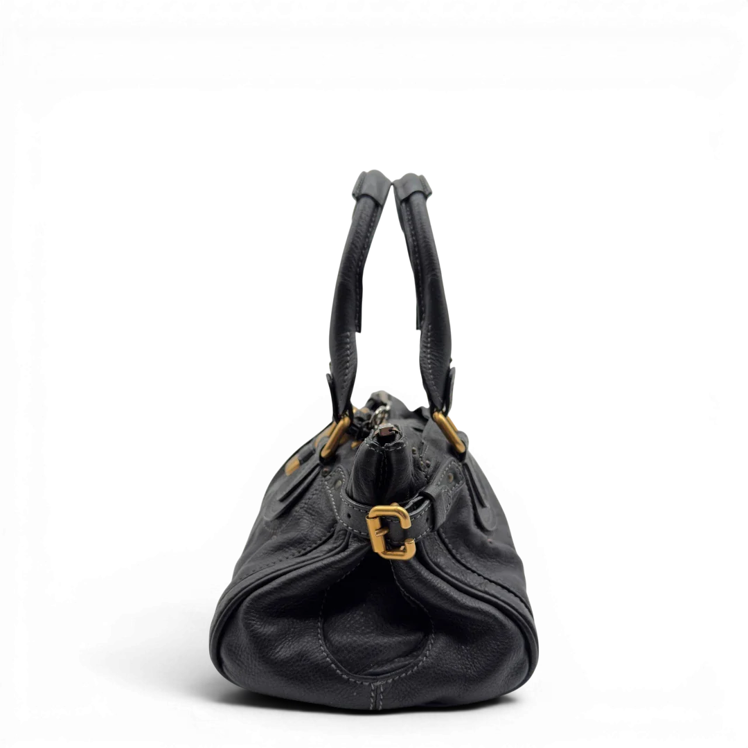 https://cdn.shopify.com/s/files/1/0564/9376/8855/files/Chloe_Handtasche_Paddington_aus_Leder_schwarz_vintage7227.webp?v=1778683778