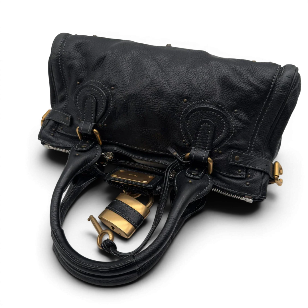 https://cdn.shopify.com/s/files/1/0564/9376/8855/files/Chloe_Handtasche_Paddington_aus_Leder_schwarz_vintage7233.webp?v=1778683779