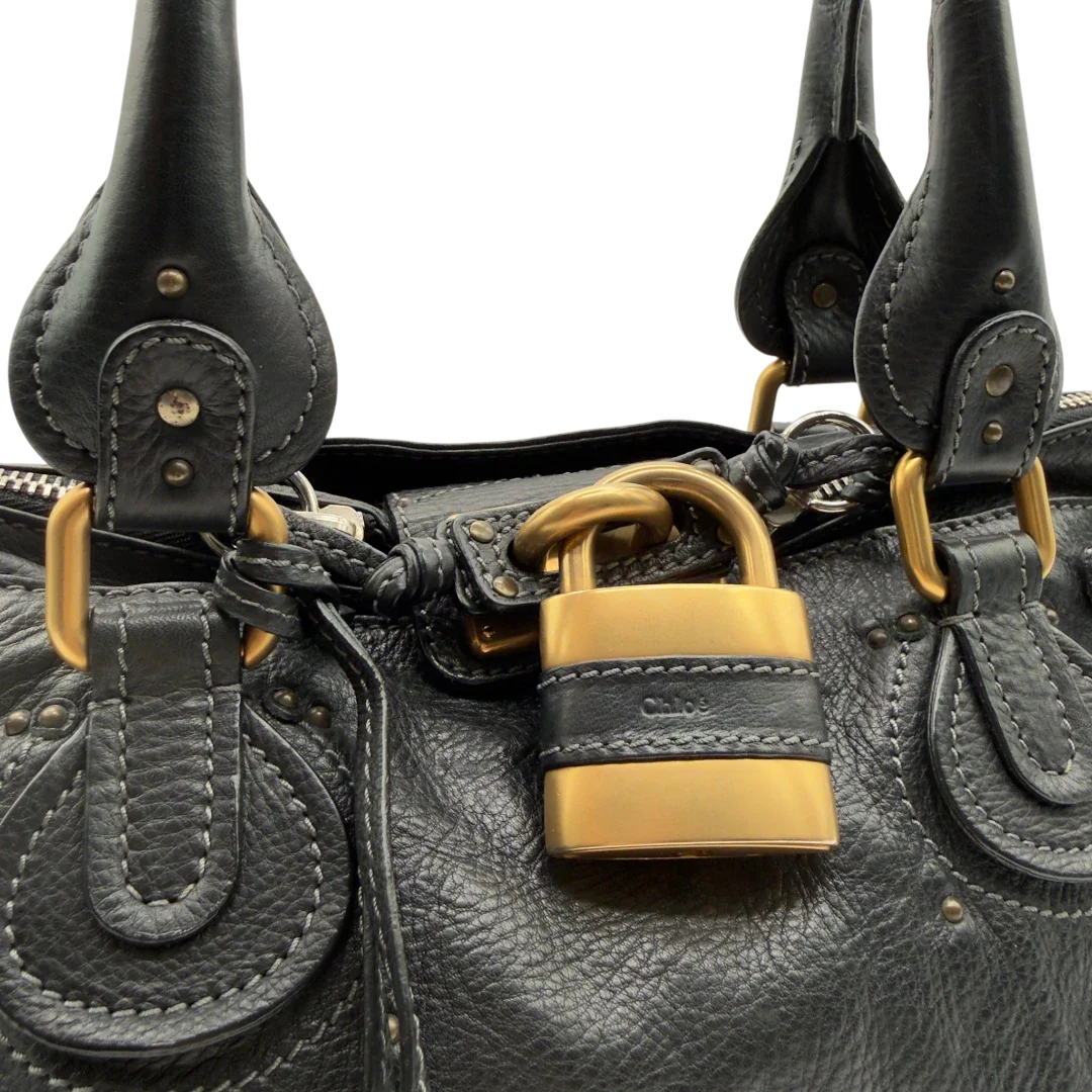 https://cdn.shopify.com/s/files/1/0564/9376/8855/files/Chloe_Handtasche_Paddington_aus_Leder_schwarz_vintage7234.webp?v=1778683779