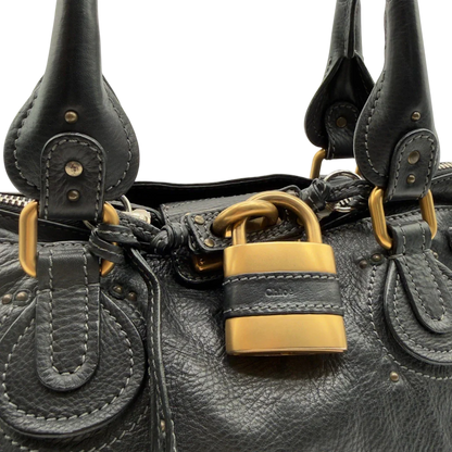 https://cdn.shopify.com/s/files/1/0564/9376/8855/files/Chloe_Handtasche_Paddington_aus_Leder_schwarz_vintage7234.webp?v=1778683779