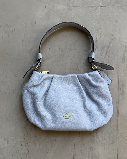 Coach Lilac Blue Leather Shoulder Bag-on a concrete background