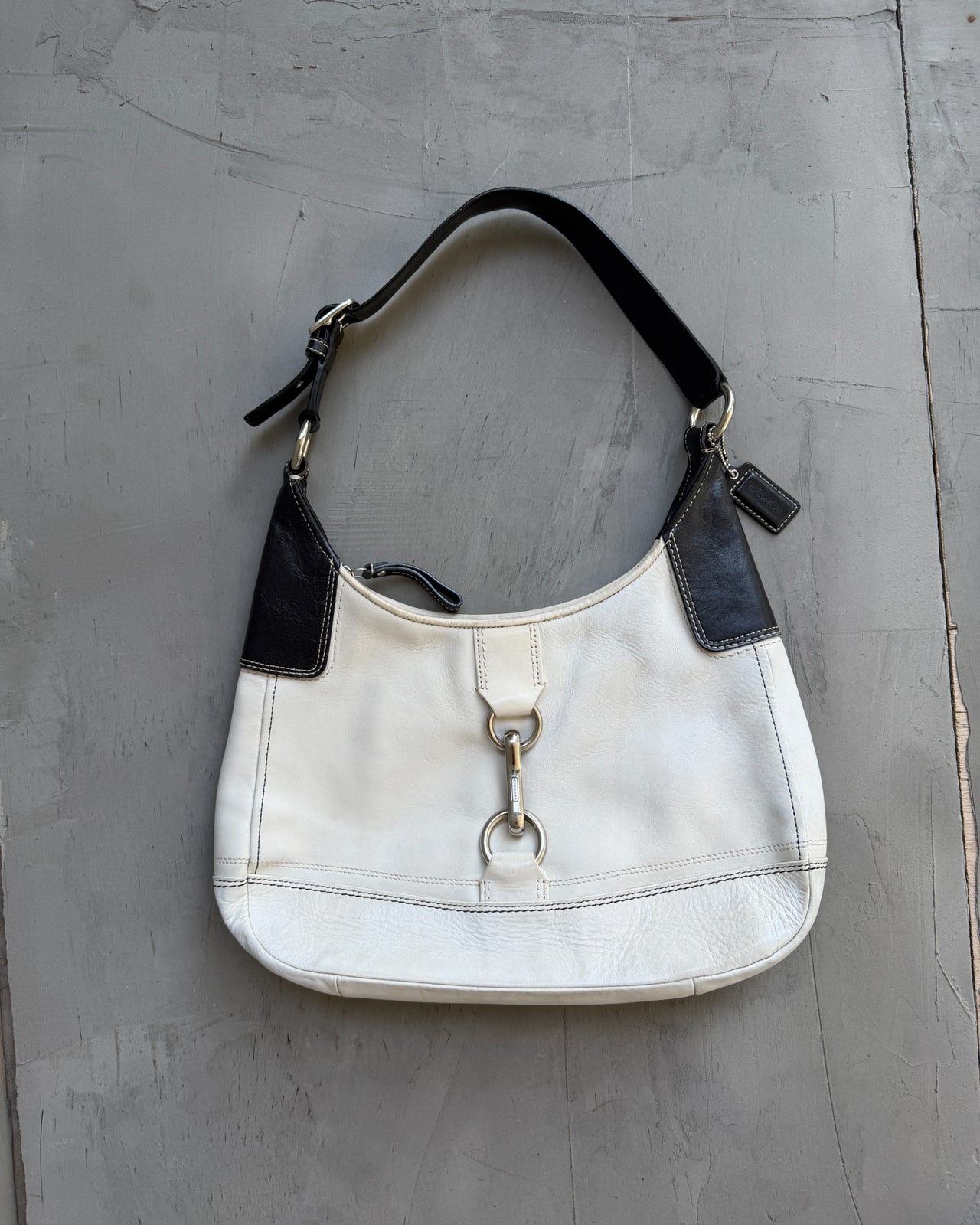 Coach Two Tone Leather Shoulder Bag-on a concrete background