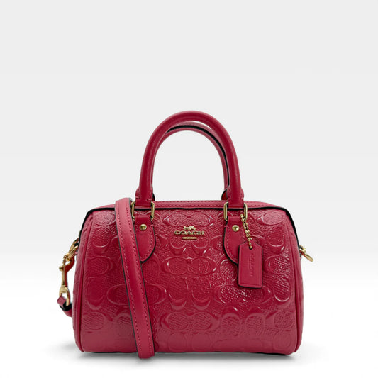https://cdn.shopify.com/s/files/1/0564/9376/8855/files/Coach_Handtasche_Mini_Boston_aus_Leder_pink_vintage_4542.webp?v=1765402337
