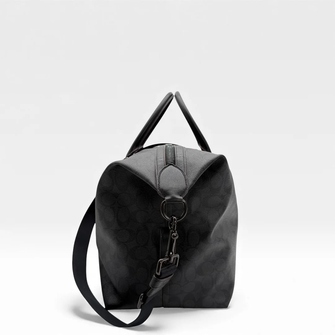 https://cdn.shopify.com/s/files/1/0564/9376/8855/files/Coach_Reisetasche_45_Signature_schwarz_vintage_dufflebag_5884.webp?v=1765451513