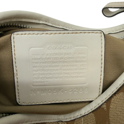 https://cdn.shopify.com/s/files/1/0564/9376/8855/files/Coach_Schultertasche_Hobo_Signature_beige_17_7b661b12-c4e6-4973-8ec7-036ff5e12daa.webp?v=1782904467
