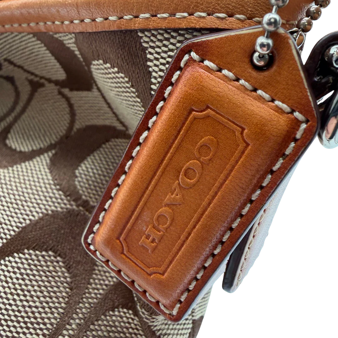 https://cdn.shopify.com/s/files/1/0564/9376/8855/files/Coach_Schultertasche_Jackie_Bucket_Signature_beige_12.webp?v=1782312193