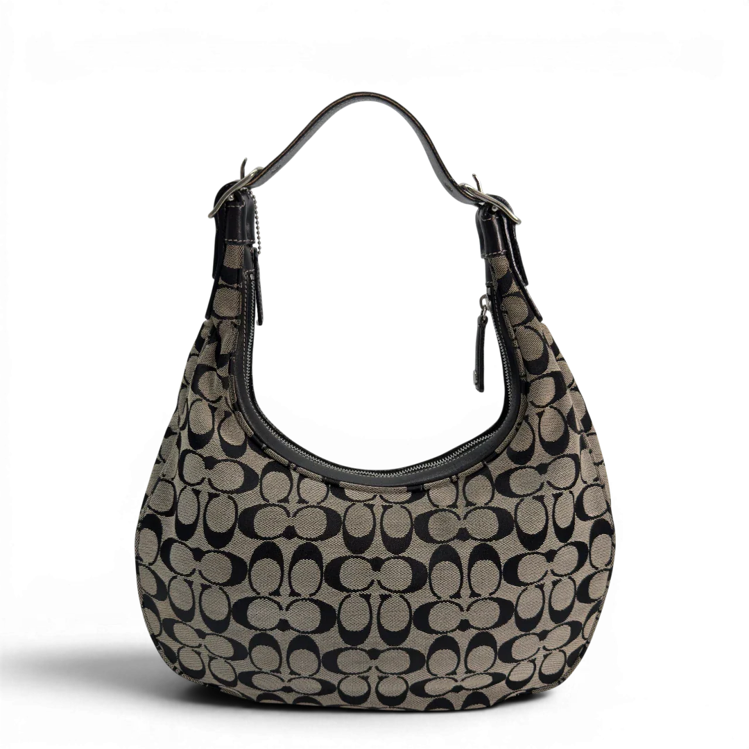 https://cdn.shopify.com/s/files/1/0564/9376/8855/files/Coach_Schultertasche_Signature_beige___schwarz_vintage8706.webp?v=1781084794