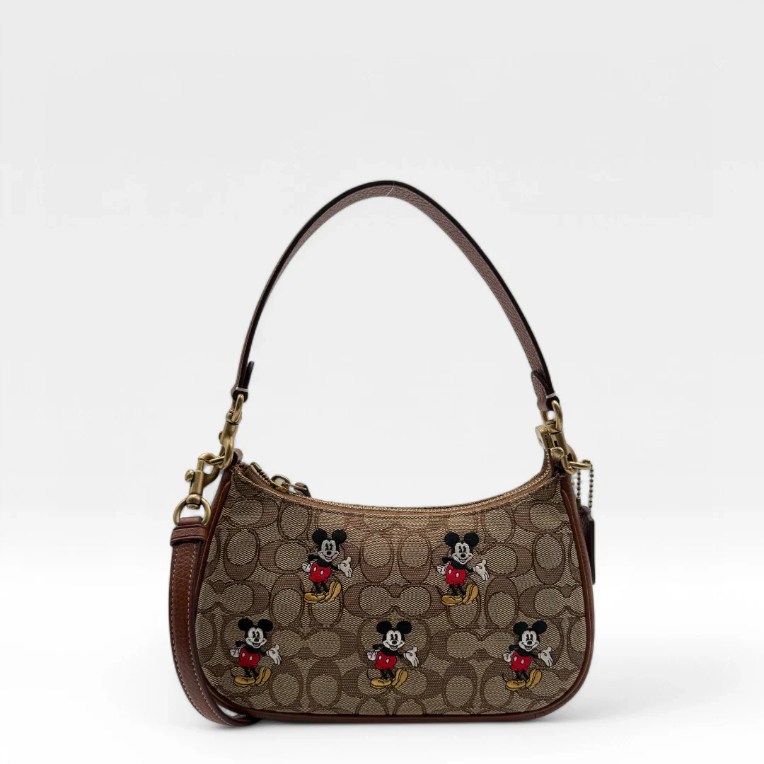 https://cdn.shopify.com/s/files/1/0564/9376/8855/files/Coach_x_Disney_Handtasche_Pochette_mit_Umhaengegurt_monogram_braun_vintage_luxury_handbag_2607.webp?v=1743622401
