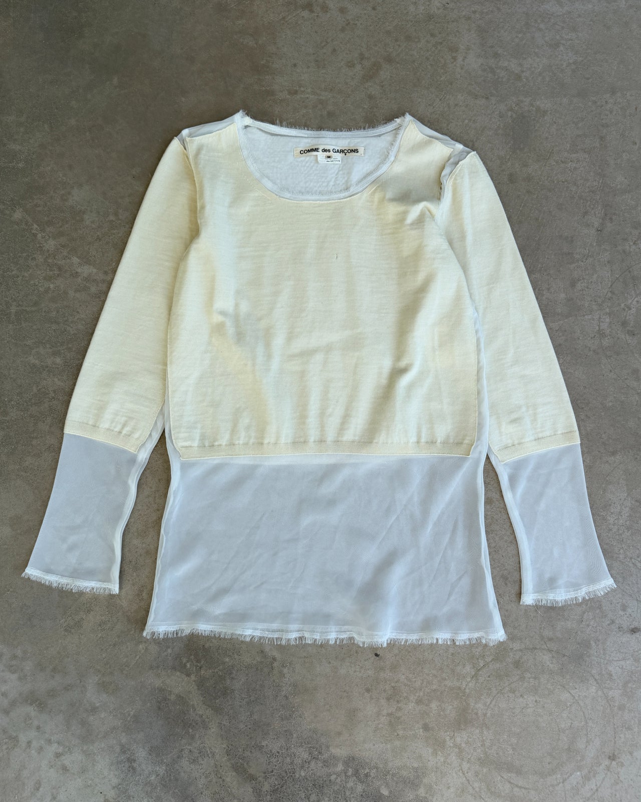 Comme des Garçons AW2012 Wool and Mesh Long Sleeve T-Shirt – M-on a concrete background