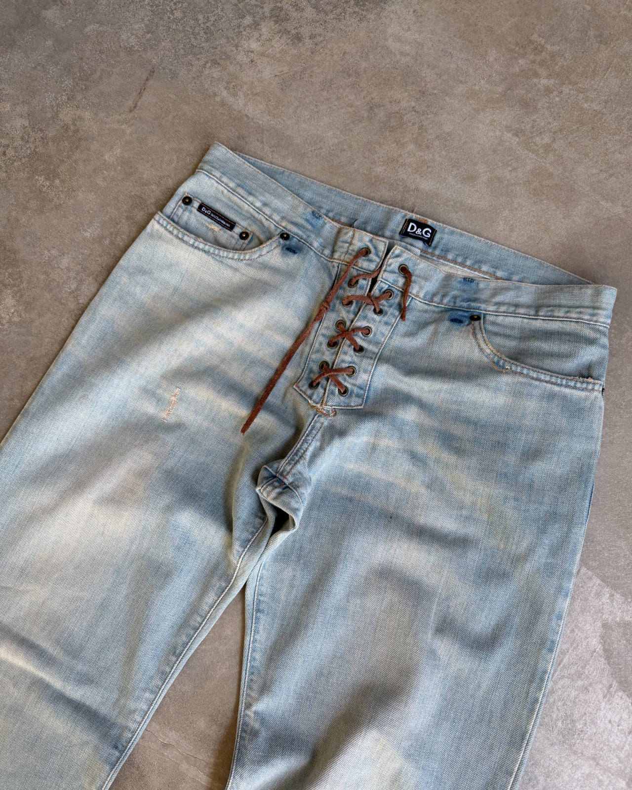 Dolce & Gabbana Light Blue Distressed Wide Leg Jeans with Leather Lace Up Fly – M-on a concrete background