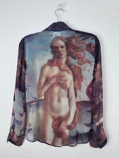 A sheer mesh shirt featuring a printed classical painting of a nude female figure, draped over a black hanger against a plain white background.