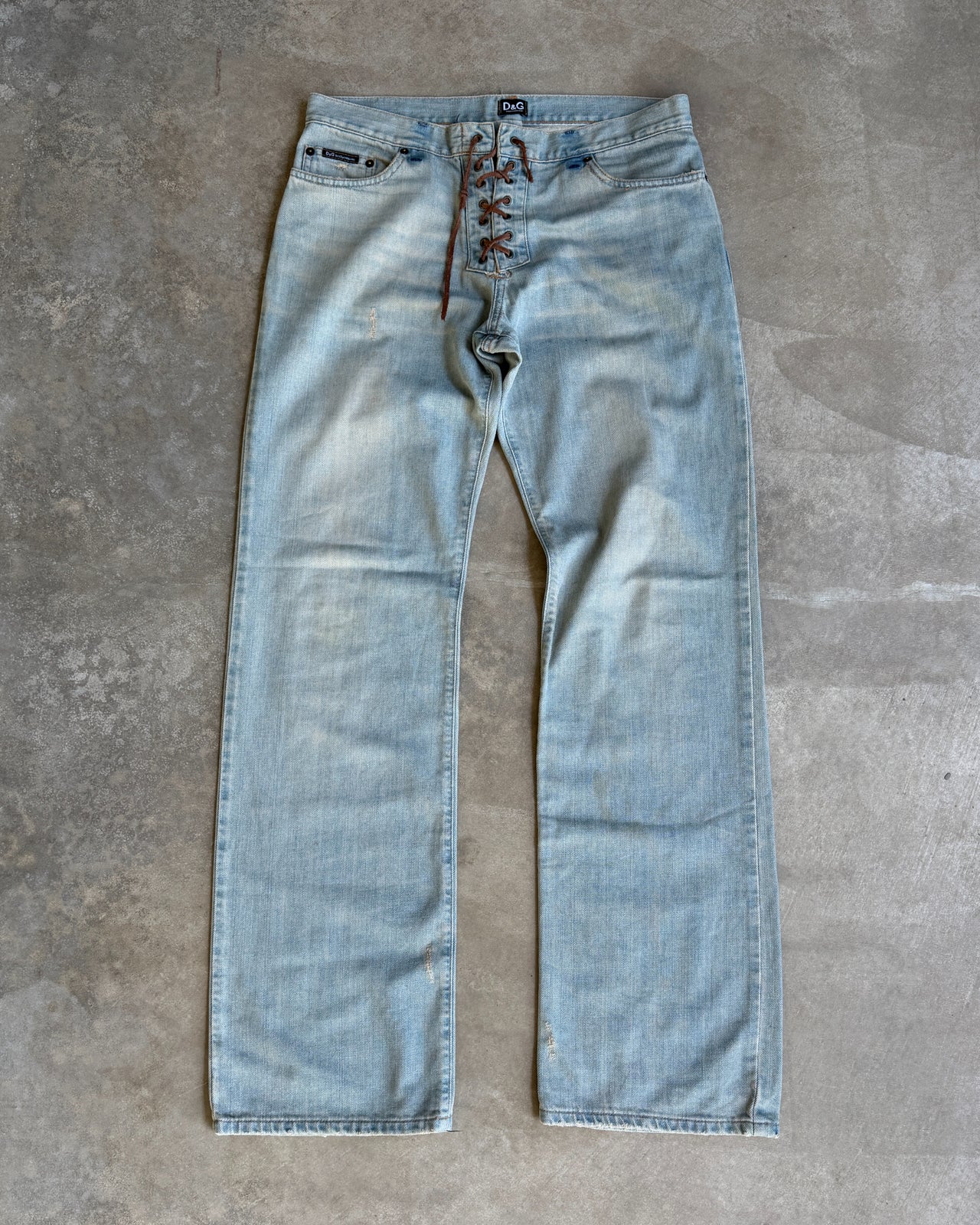 Dolce & Gabbana Light Blue Distressed Wide Leg Jeans with Leather Lace Up Fly – M-on a concrete background
