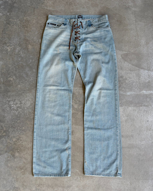 Dolce & Gabbana Light Blue Distressed Wide Leg Jeans with Leather Lace Up Fly – M-on a concrete background