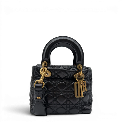 https://cdn.shopify.com/s/files/1/0564/9376/8855/files/Dior_Handtasche_Lady_Dior_medium_aus_Lammleder_schwarz_vintage8403.webp?v=1780486575