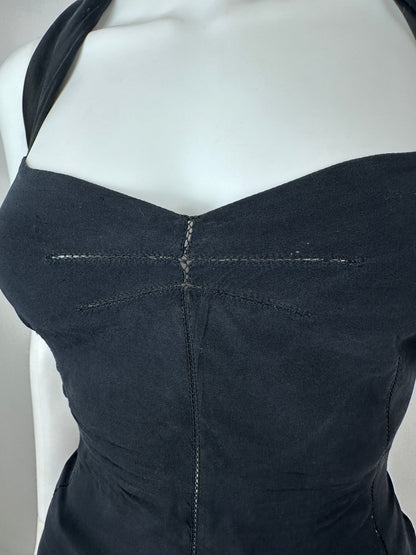 Close-up of the back of a black strapless dress or bodysuit displayed on a white mannequin torso, showing seam details and a V-shaped back cut.