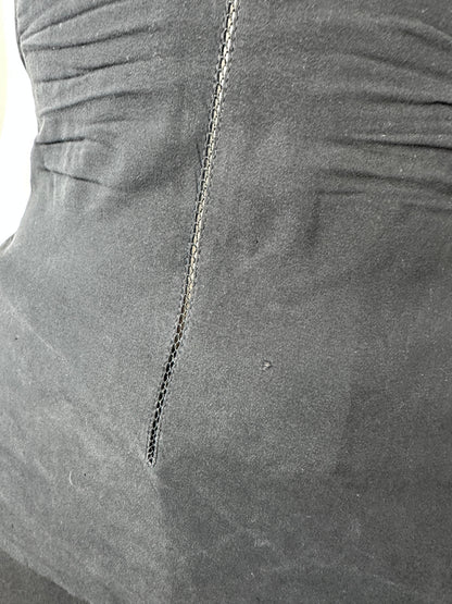 Close-up of a dark gray fabric surface with a visible seam and stitched detail.