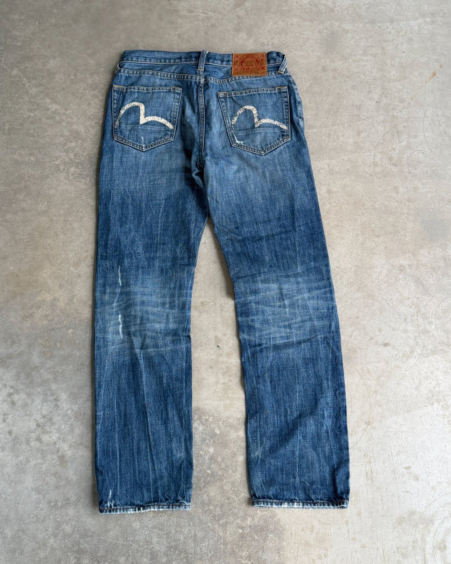 Vintage Evisu Jeans – W30–31-on a concrete background