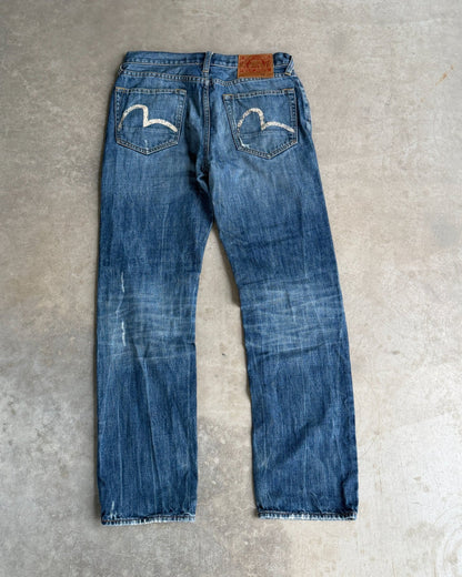 Vintage Evisu Jeans – W30–31-on a concrete background