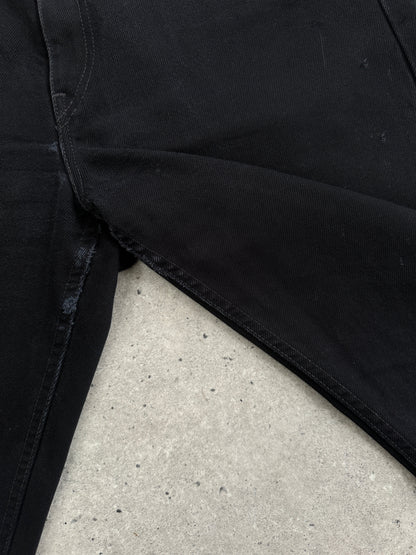 Levi’s 521 tapered straight leg denim jeans in W31, showing classic blue denim fabric and fitted cut on a hanger.