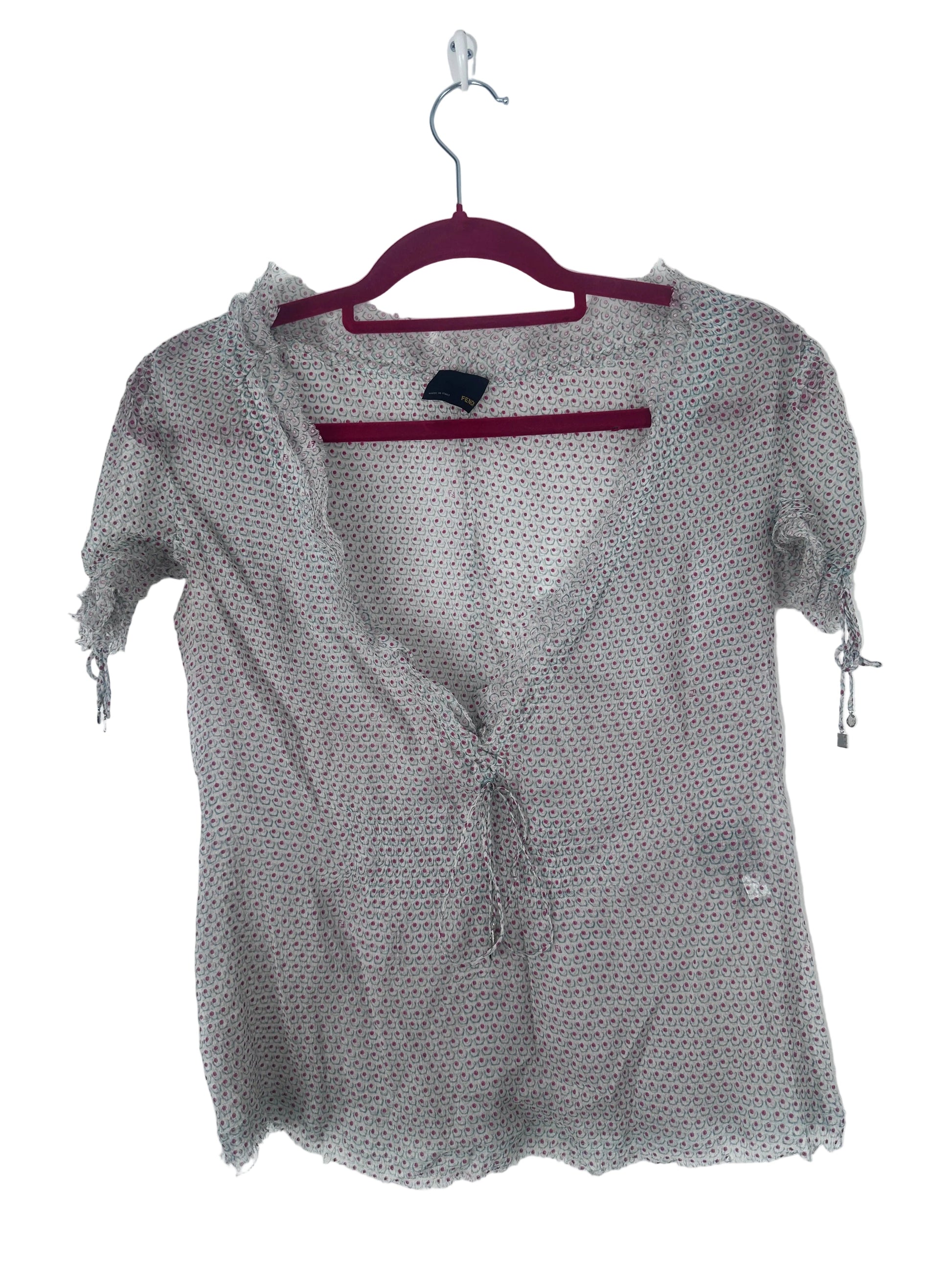 A sheer, lightweight gray mesh cardigan with a tiny white polka dot pattern, hanging on a dark red hanger against a plain white background.