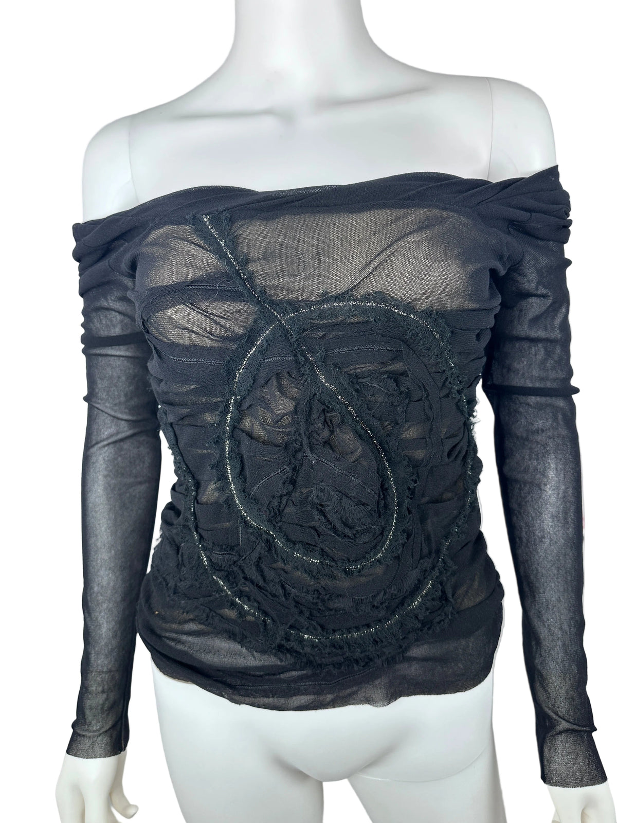 Black sheer top on a mannequin with a white background