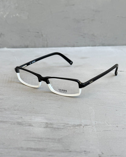 Guess Two Tone Black and White Clear Lens Glasses-on a concrete background