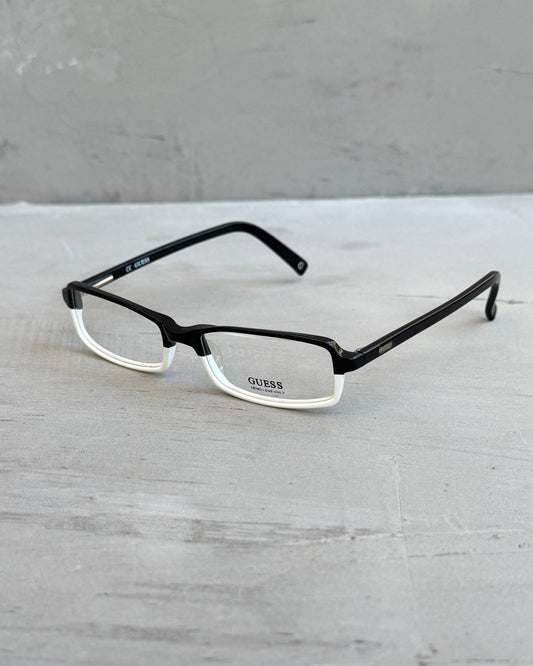 Guess Two Tone Black and White Clear Lens Glasses-on a concrete background