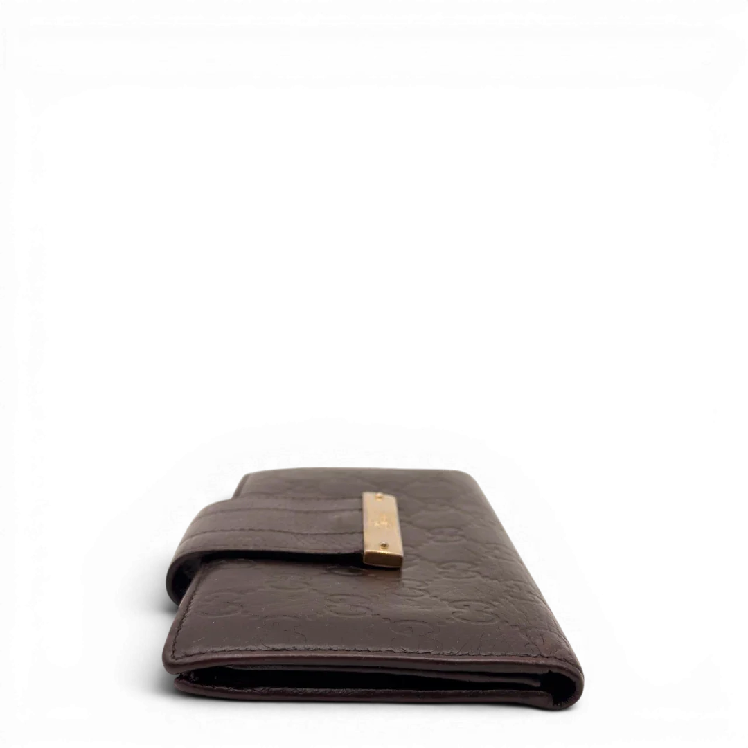 https://cdn.shopify.com/s/files/1/0564/9376/8855/files/Gucci_Geldbeutel_Bifold_langlich_aus_Leder_monogram_dunkelbraun_3.webp?v=1784242158