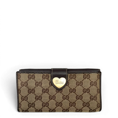 https://cdn.shopify.com/s/files/1/0564/9376/8855/files/Gucci_Geldbeutel_Heart_Continental_langlich_monogram_beige_1.webp?v=1783513751