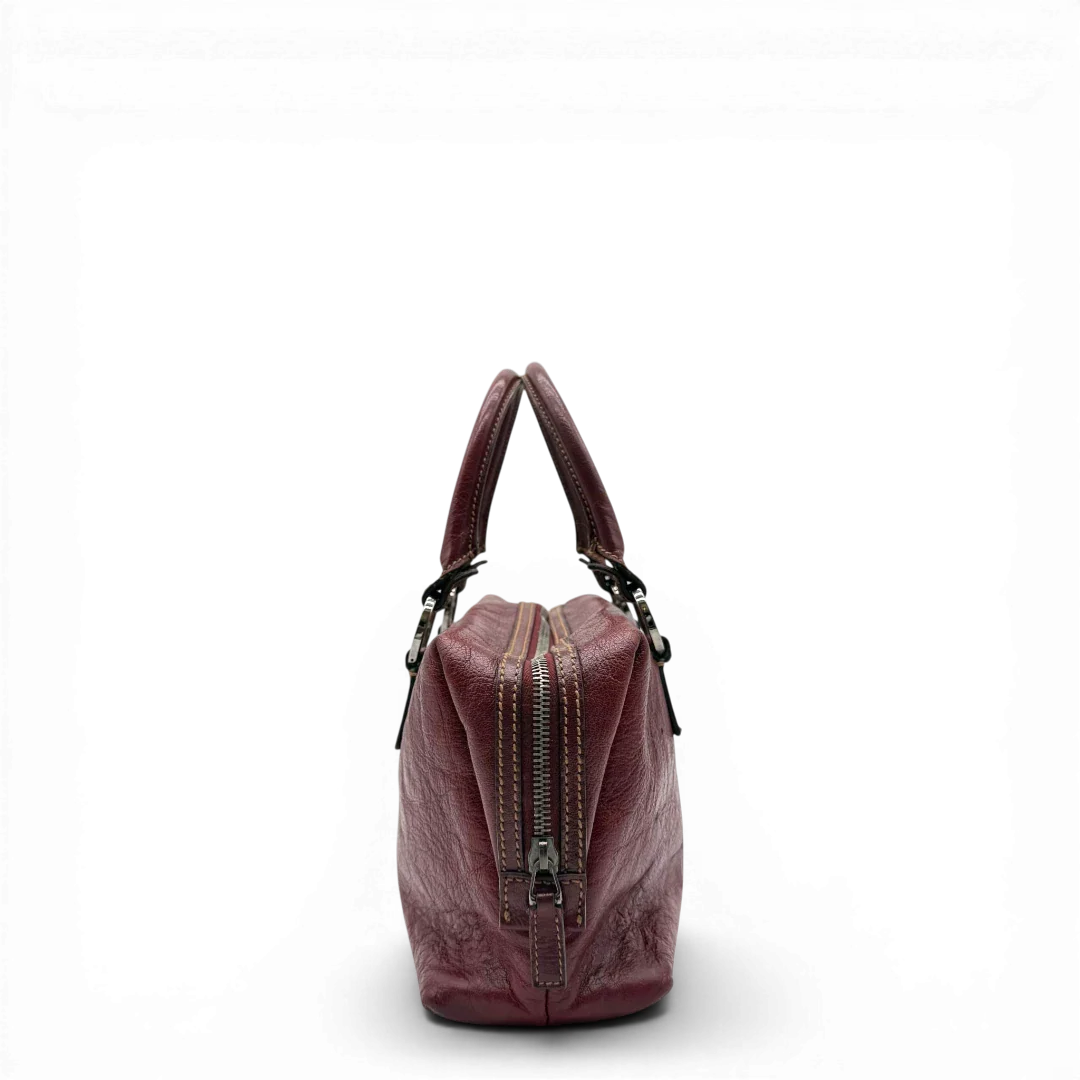 https://cdn.shopify.com/s/files/1/0564/9376/8855/files/Gucci_Handtasche_Boston_bag_aus_Leder_Rot_vintage_GG2896.webp?v=1774010468