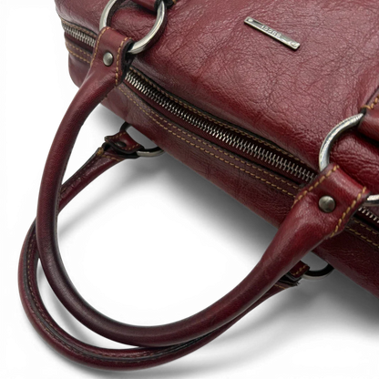 https://cdn.shopify.com/s/files/1/0564/9376/8855/files/Gucci_Handtasche_Boston_bag_aus_Leder_Rot_vintage_GG2903.webp?v=1774010468