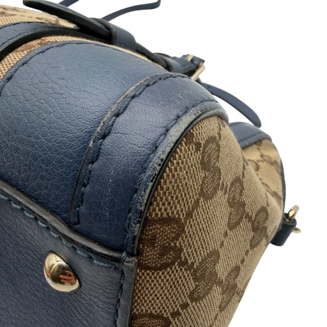 https://cdn.shopify.com/s/files/1/0564/9376/8855/files/Gucci_Handtasche_Boston_mit_Umhangegurt_monogram_beige_vintage_GG8599.webp?v=1781107385